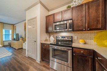 a kitchen with stainless steel appliances and wooden cabinets